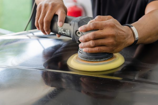 Man working for polishing, coating cars. polishing of the car will help eliminate contaminants on the surface of the car.Waxing the car surface will cause shine after polishing the car.